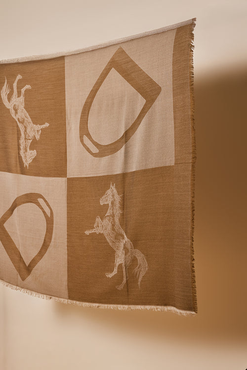 wool scarf with woven horse and stirrup design in a beige and saturated brown colour