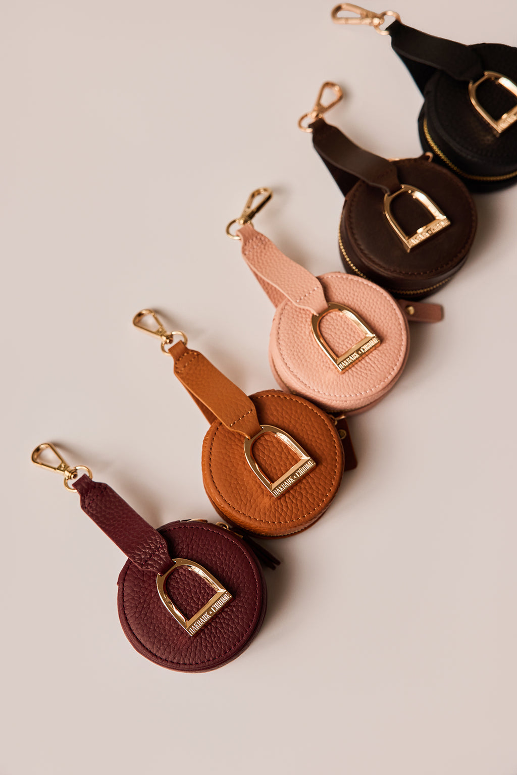 Set of round leather keychains in various colors on a light background