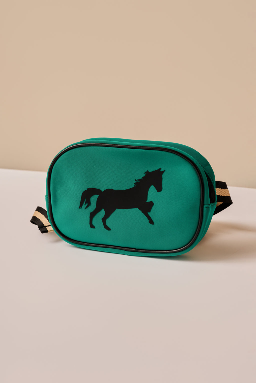 Green bag with a horse silhouette on a beige background