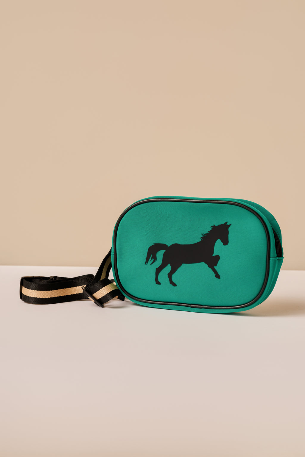 Green bag with a horse design on a beige background