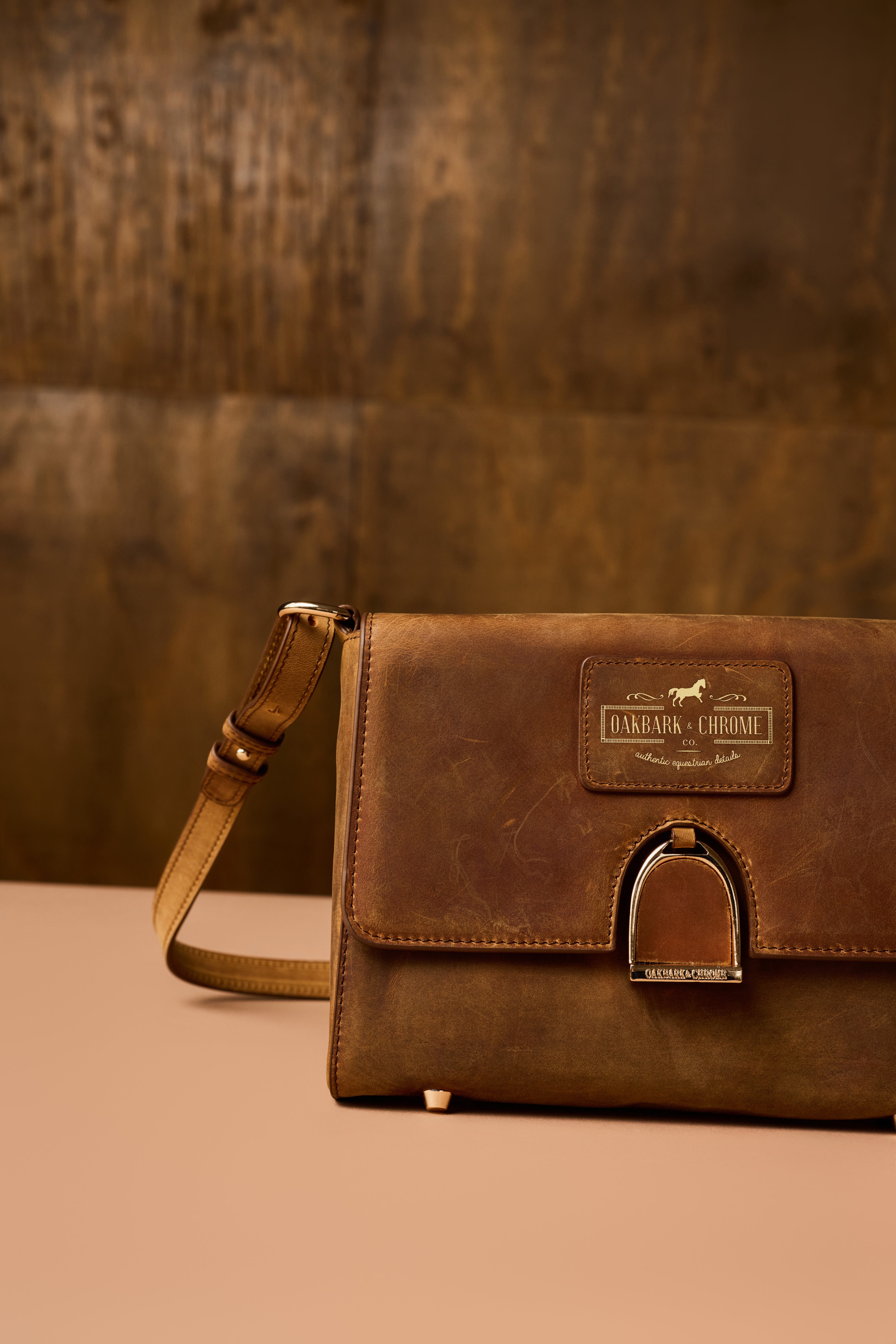 Brown leather bag with a visible brand logo on a brown background