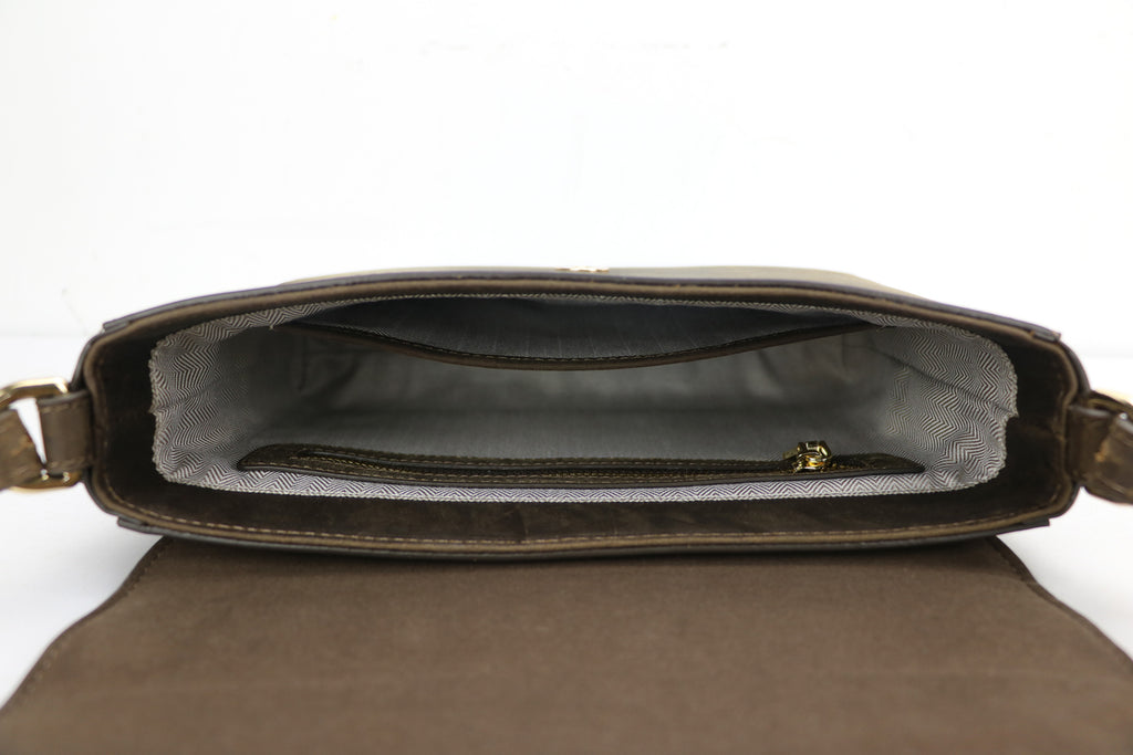 inside of a leather bag, showing a zippered pouch and an open pouch with herringbone lining